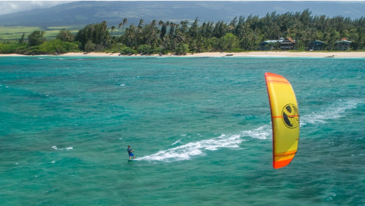 Flying a kite while kitesurfing in nature