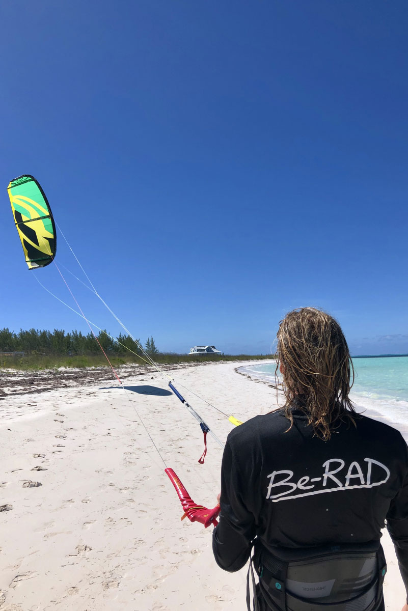 kitesurfer flying a kite at the beach